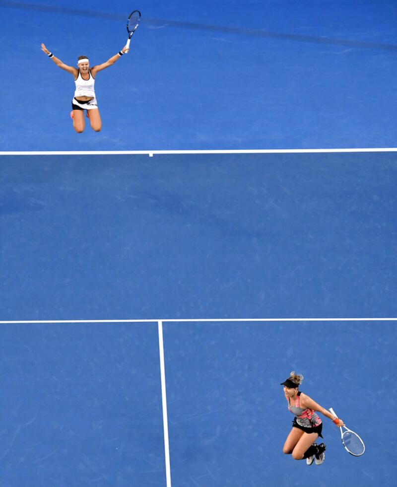Bethanie Mattek-Sands, bottom, of the US and Lucie Safarova of the Czech Republic celebrate after defeating Andrea Hlavackova of the Czech Republic and Peng Shuai of China in the women’s doubles final at the Australian Open tennis championships in Melbourne, Australia on January 27, 2017. Andy Brownbill / Associated Press