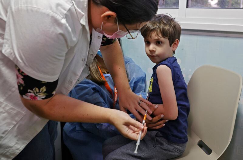 Israeli boy Itamar, 5, receives a dose of the Pfizer/BioNTech Covid-19 vaccine at the Meuhedet Healthcare Services Organisation in Tel Aviv. AFP