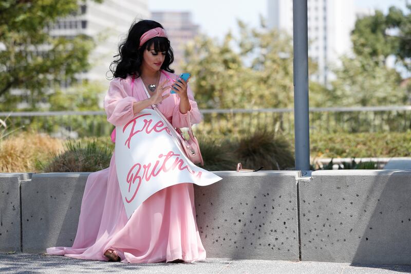 Leeni Ramadan sits during a protest in support of pop star Britney Spears on the day of a conservatorship case hearing at Stanley Mosk Courthouse in Los Angeles, California.