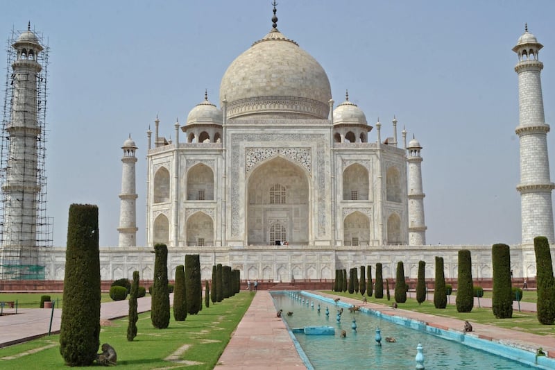 The Taj Mahal mausoleum is seen deserted apart from a few monkeys sprawling around the fountain area of the monument, after an order by the administration was issued to close all protected monuments and tourist spots for a duration of a month to curb the spread of Covid-19 coronavirus infections in Agra on April 15, 2021. (Photo by Pawan SHARMA / AFP)