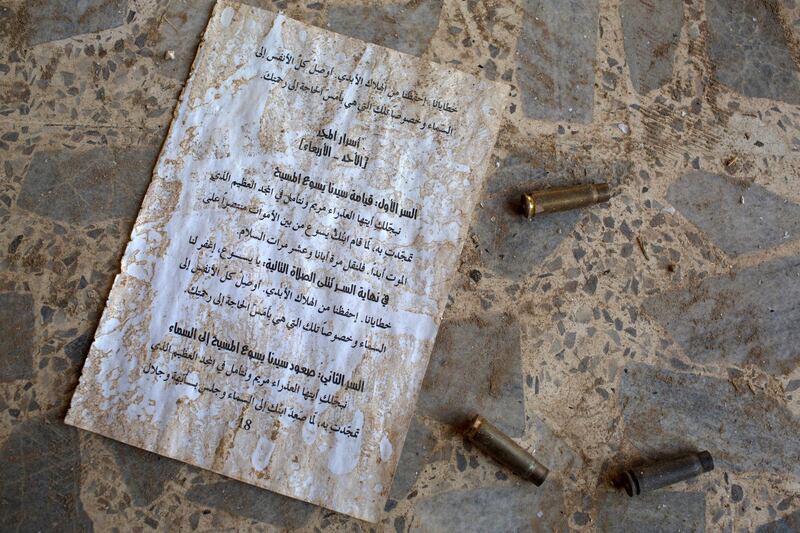 QARAQOSH, IRAQ - NOVEMBER 08: Bullet casings are seen next to a sheet of Christian writings on the ground of the  burnt and destroyed St Mary al-Tahira church on November 8, 2016 in Qaraqosh, Iraq. The NPU is a military organization made up of Assyrian Christians and was formed in late 2014 to defend against ISIL. Qaraqosh, a largely Assyrian City just 32km southeast of Mosul was taken by ISIL in August, 2014 forcing all residents to flee, the town was largely destroyed with all of the churches burned or heavily damaged. The town stayed under ISIL control last week when it was liberated during the Mosul Offensive.  (Photo by Chris McGrath/Getty Images)