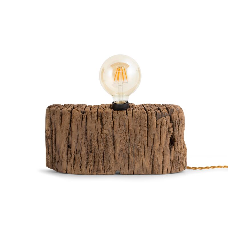 A bare bulb attached to a well-worn piece of wood are the features of this lamp from Flamant