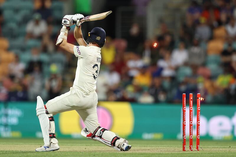 England's Mark Wood is bowled by Pat Cummins. Getty