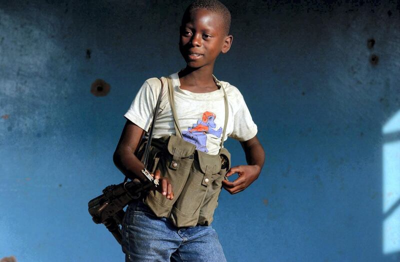 epa02576447 (FILE) A file picture dated 16 June 2003 shows a young child soldier who would not give his age to journalists in an ethnic Hema militia camp near Bunia in the Democratic Republic of Congo. On 12 February 2011 Red Hand Day will be observed worldwide through protest, demonstrations and other activities to raise awareness of the situation of child soldiers across the globe. Red Hand Day is takes place yearly on 12 February.  EPA/STEPHEN MORRISON *** Local Caption *** 02576447