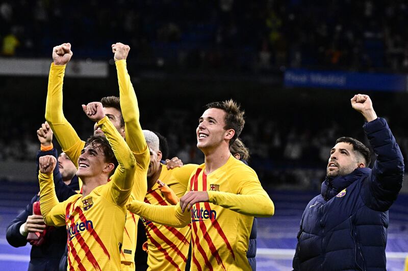 Barcelona's players celebrate their 4-0 La Liga win over Real  at the Santiago Bernabeu on March 20, 2022. AFP