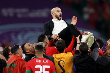 DOHA, QATAR - DECEMBER 10: Walid Regragui, Head Coach of Morocco, celebrates with the team after the 1-0 win  during the FIFA World Cup Qatar 2022 quarter final match between Morocco/Spain and Portugal/Switzerland at Al Thumama Stadium on December 10, 2022 in Doha, Qatar. (Photo by Francois Nel / Getty Images)