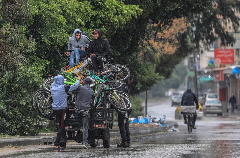 epa09099291 Palestinians ride a motorcycle cart amid the ongoing coronavirus COVID-19 pandemic in Gaza City on, 26 March 2021. The Ministry of Interior in Gaza City announced new measures on 24 March 2021, as coronavirus cases increase.  EPA/MOHAMMED SABER