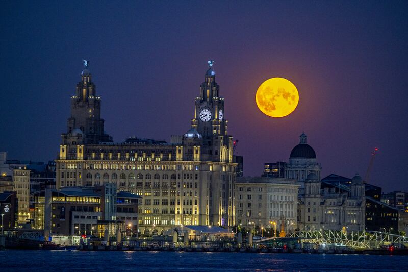 A sturgeon supermoon rises over the Royal Liver Building in Liverpool in August 2022. PA