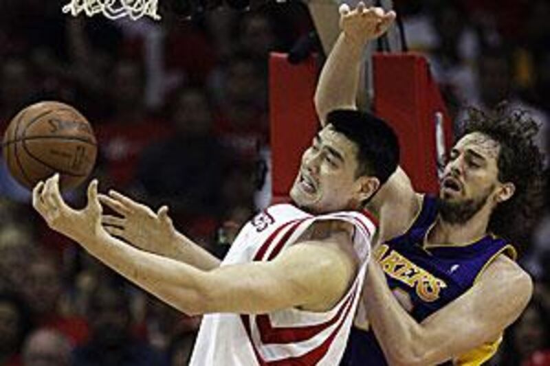 Yao Ming, left, pictured battling the Los Angeles Lakers' Pau Gasol, will undergo further tests on the injury that is threatening his career.