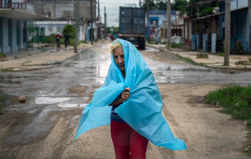 Plastic provides some protection from the rain in Batabano. AP Photo