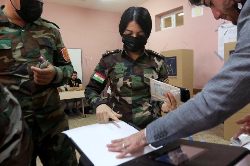A member of the Kurdish Peshmerga military votes in Erbil. Reuters