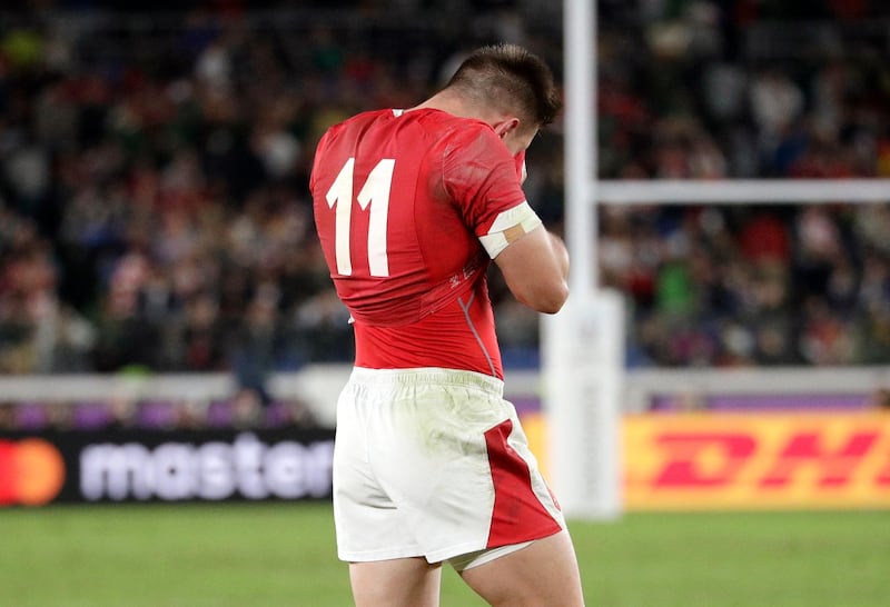 Wales' Josh Adams wipes his face after his team's loss to South Africa in their Rugby World Cup semifinal at International Yokohama Stadium in Yokohama, Japan.  AP