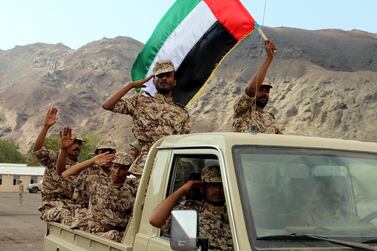 Yemeni soldiers trained by Emirati troops wave a UAE flag during combat training. EPA