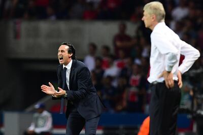 (FILES) In this file photo taken on September 13, 2016, Paris Saint-Germain's Spanish head coach Unai Emery (L) gestures next to Arsenal's French manager Arsene Wenger during the UEFA Champions League Group A football match between Paris-Saint-Germain vs Arsenal FC, at the Parc des Princes stadium in Paris. Unai Emery has been appointed as the new manager of Arsenal, the club announced on May 23, 2018. "Unai Emery is to become our new head coach," said a statement on the club's website. "He joins the club after completing a two-year spell at Paris Saint-Germain, where he recently landed the treble of Ligue 1, Coupe de France and the Coupe de la Ligue." / AFP / FRANCK FIFE AND FRANCK FIFE
