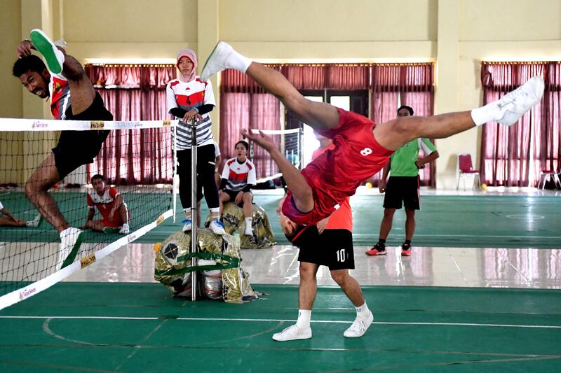 This photo taken on May 22, 2017 shows a member of Indonesia's national sepak takraw team performing an overhead kick to fire a ball over the net during a training session at an elite police force base in Jambi. AFP / Goh Chai Hin