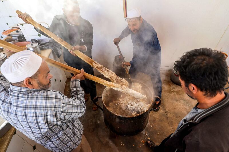 Volunteers cook together portions of the traditional Libyan dish "Bazin", which consists of a dough made with barley, water, and salt in the coastal city of Tajura east of Tripoli, to be distributed to needy families during the Muslim holy fasting month of Ramadan.  AFP