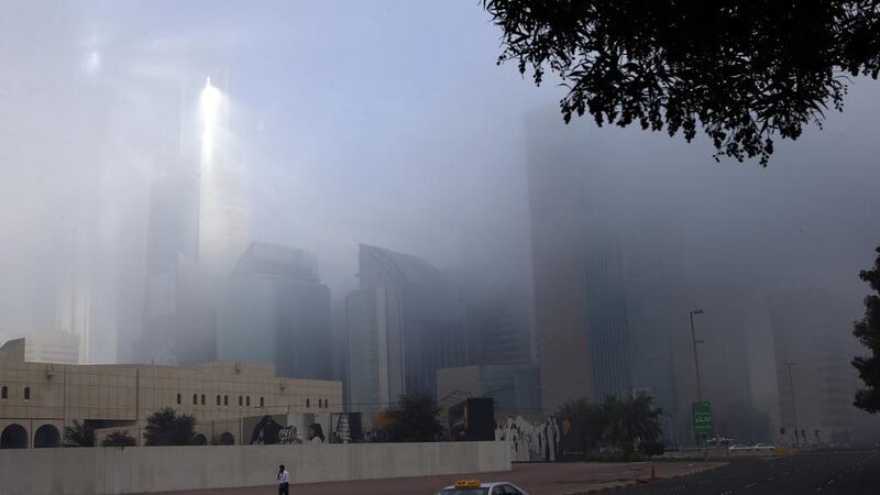 Sun rays pass through the thick fog on Hamdan street in Abu Dhabi.