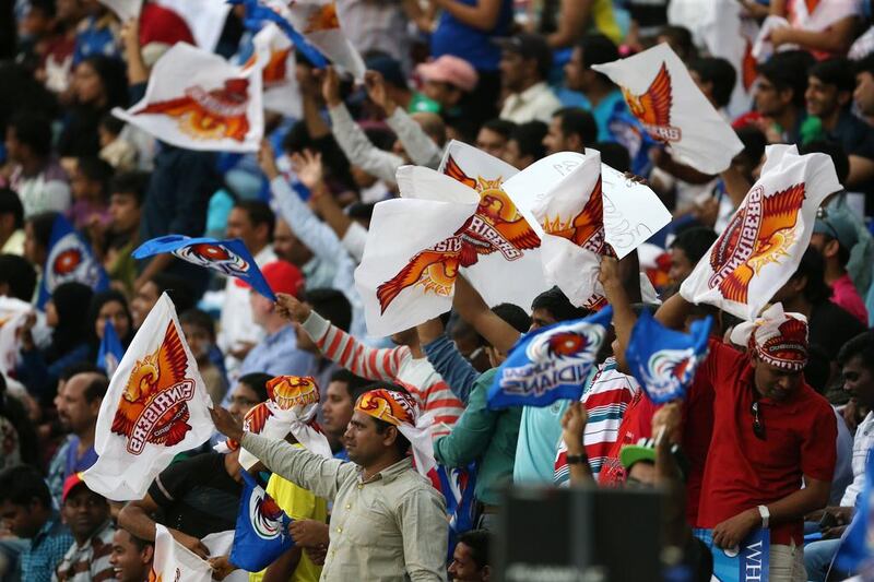Fans waving flags as they watch the IPL contest between Sunrisers Hyderbad and Mumbai Indians in Dubai on Wednesday. Pawan Singh / The National / April 30, 2014