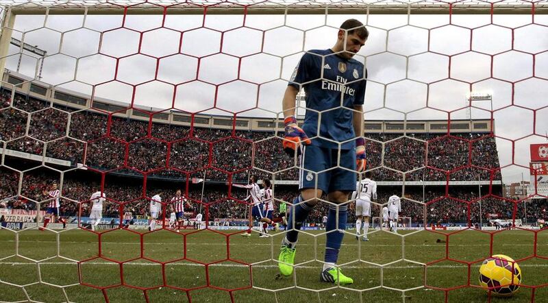 Real Madrid goalkeeper Iker Casillas picks up the ball after the fourth goal in his team's 4-0 loss to Atletico Madrid on Saturday. Juanjo Martin / EPA