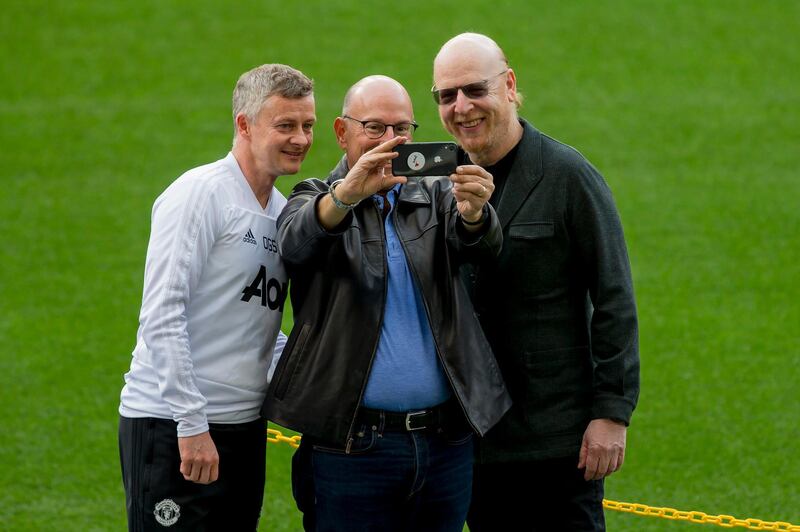Manchester United's manager Ole Gunnar Solskjaer, left, takes a selfie with club owners Joel Glazer, centre, and Avram Glazer. AP Photo