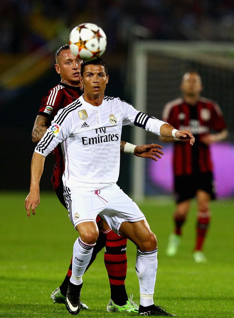 DUBAI, UNITED ARAB EMIRATES - DECEMBER 30:Cristiano Ronaldo of Real Madrid is watched by Philleppe Mexes of AC Milan  during the Dubai Football Challenge match between AC Milan and Real Madrid at The Sevens Stadium  on December 30, 2014 in Dubai, United Arab Emirates.  (Photo by Francois Nel/Getty Images)