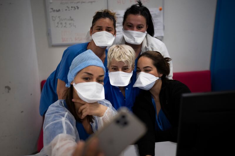 Hospital workers gather for a selfie in the Covid-19 intensive care unit of the La Timone hospital in Marseille, southern France. One of the country’s largest hospitals, La Timone has weathered wave after wave of coronavirus. AP