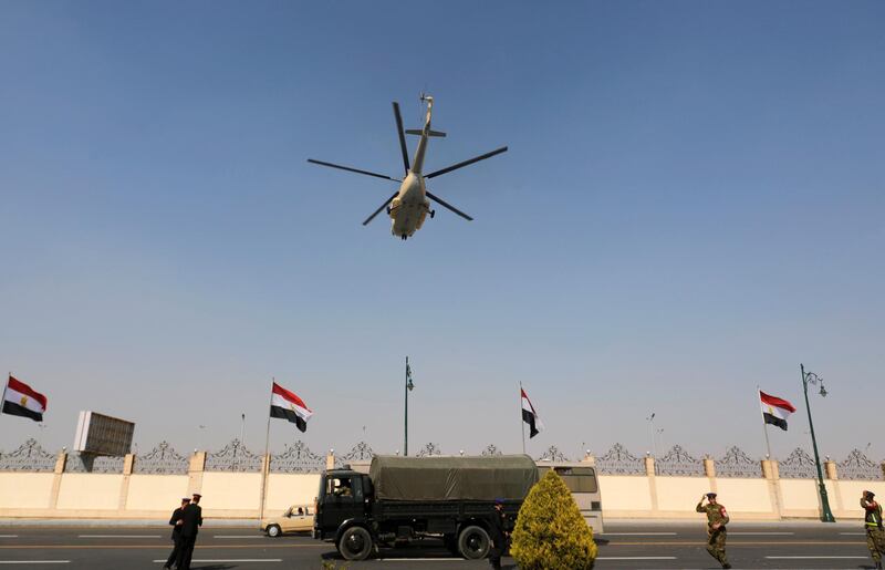 A helicopter carrying the coffin of former Egyptian President Hosni Mubarak flies during his funeral. Reuters