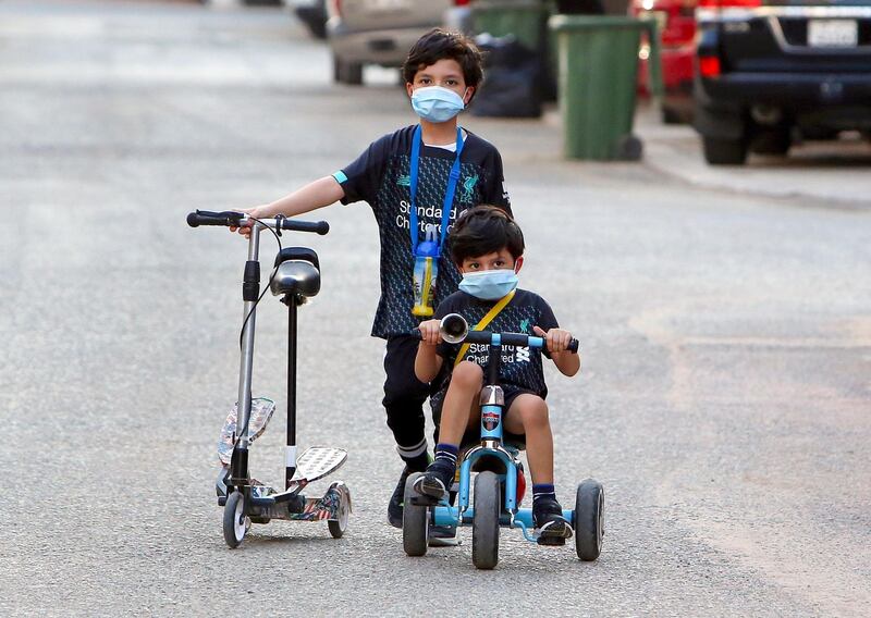 Kuwaiti children cycle in a street in the Salwa district of Kuwait City.   AFP