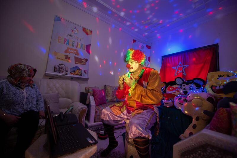 epa08370887 A Moroccan man Salah, dressed as a clown, performs for children via live broadcast in the Internet in Rabat, Morocco, 17 April 2020 (issued 18 April 2020). Salah's broadcast aims to entertain children in light of the curfew in the country knows after the Moroccan authorities declared a state of health emergency nearly a month ago to stem the widespread of the SARS-CoV-2 coronavirus which causes the Covid-19 disease.  EPA/JALAL MORCHIDI