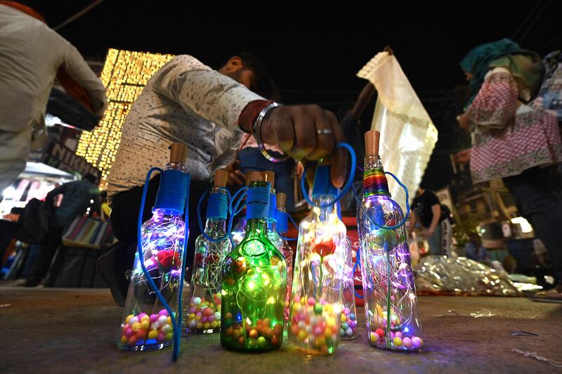 A vendor arranges decorative lights at a market in New Delhi. AFP