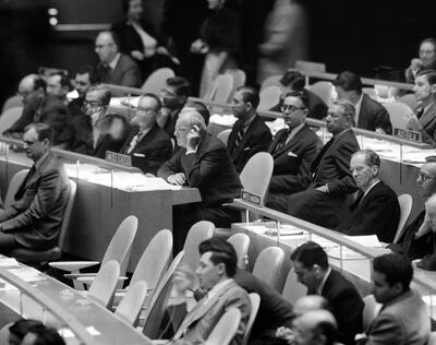 U.S. secretary of state John Foster Dulles, left and British Delegate Sir Pierson Dixon, right, sit on opposite side of the aisle at United Nations General Assembly meeting on Nov. 2, 1956 in New York, during voting on a resolution urging an immediate cease-fir in Egypt. They were also on opposite side in the voting. (AP Photo)