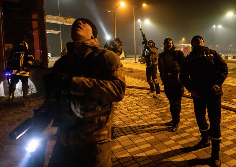 Ukrainian police officers stand near a warehouse that was hit by the debris of a downed rocket in Kyiv. AFP