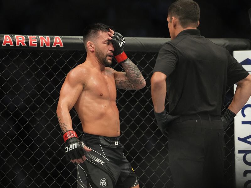 Pedro Munhoz reacts after being accidentally poked in the eye during his fight against Sean O'Malley. USA TODAY Sports