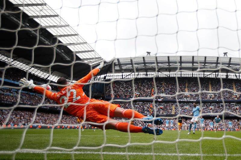 Leeds United keeper Joel Robles dives as Manchester City's Ilkay Gundogan misses from the penalty spot. Reuters