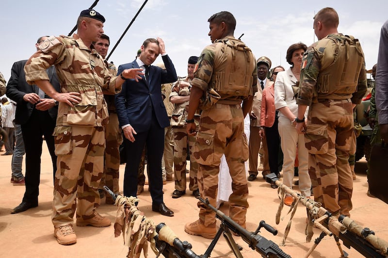 French President Emmanuel Macron visits soldiers of Operation Barkhane in Gao in 2017. He expressed his 'deep sadness' at the news. AP