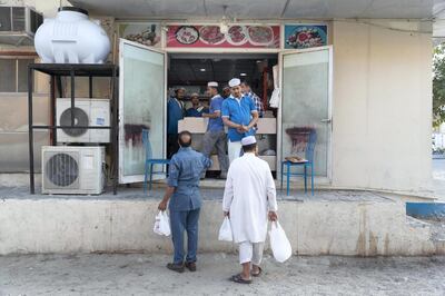 DUBAI, UNITED ARAB EMIRATES. 15 MAY 2019. Small Sub Continent restaurants in Dubai that serve lower income expats and labourers serve traditional food specially prepared for the Iftar rush through specially set up stalls outside of their usual stationary businesses during the month of Ramadan. Food being served at the Ashbilia restaurant in Al Quoz One. (Photo: Antonie Robertson/The National) Journalist: Anna Zacharias. Section: National.