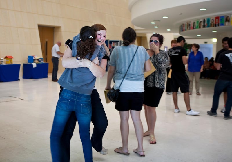 British School al Khubairat student Natalie Christodoulides, 17, gets a hug from a fellow student as they react to their A-level test results on Thursday, August 18, 2011, at the school in Abu Dhabi. Thousands of students around the Commonwealth nations received their results today. In Abu Dhabi, some came in person but others called in for their results as they were still traveling on their summer vacations. (Silvia Razgova/The National)

