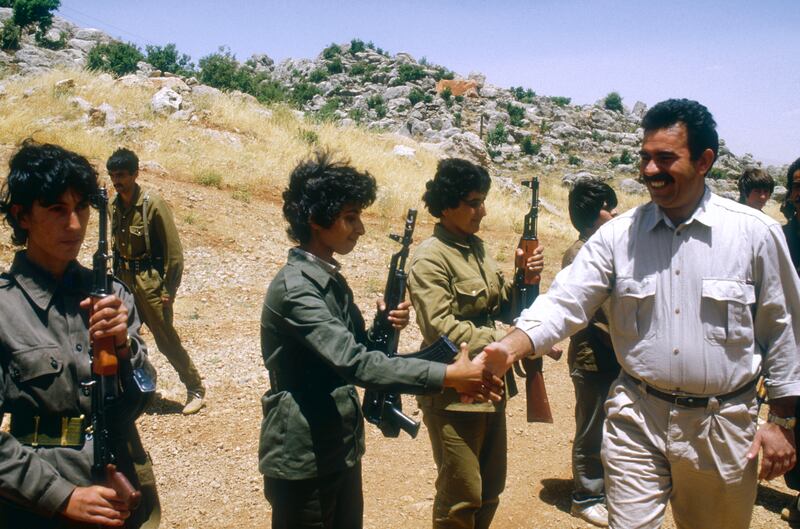 Kurdistan Workers' Party (PKK) leader Abdullah Ocalan greets women soldiers at the Mahsun Korkmaz Academy military training camp in Lebanon on June, 18, 1988. Getty Images