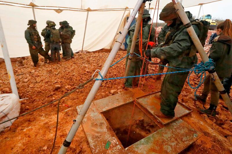 (FILES) In this file photo taken on December 19, 2018 A picture taken on December 19, 2018 during a guided tour by the Israeli army shows an Israeli soldier operating a pulley while standing outside an entry point made by the army to intercept a tunnel which reportedly connects between Lebanon and Israel, near the border near the northern Israeli town of Metula. Israel has uncovered all cross-border attack tunnels dug by Hezbollah from Lebanon and now plans to bring its operation to find and destroy them to an end, a military spokesman said today. / AFP / JACK GUEZ
