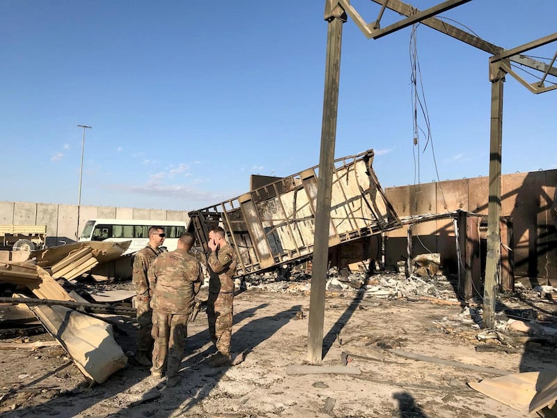 U.S. soldiers are seen at the site where an Iranian missile hit at Ain al-Asad air base in Anbar province, Iraq.  Reuters