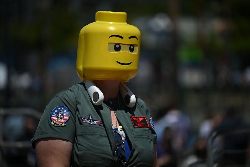 A cosplayer wears a 'Top Gun' jacket and a Lego head. AFP