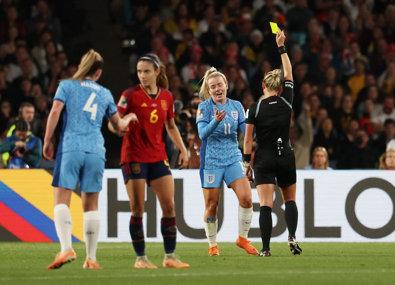 England's Lauren Hemp is shown a yellow card by referee Tori Penso. Reuters