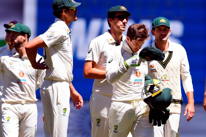 Australia captain Tim Paine leads his team off the field after their defeat to India. AFP