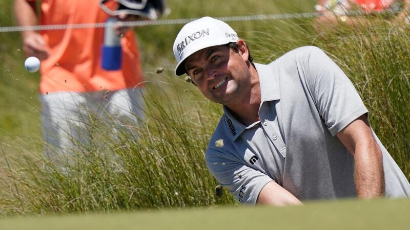 Keegan Bradley chips to the 18th green during his first-round 69. AP