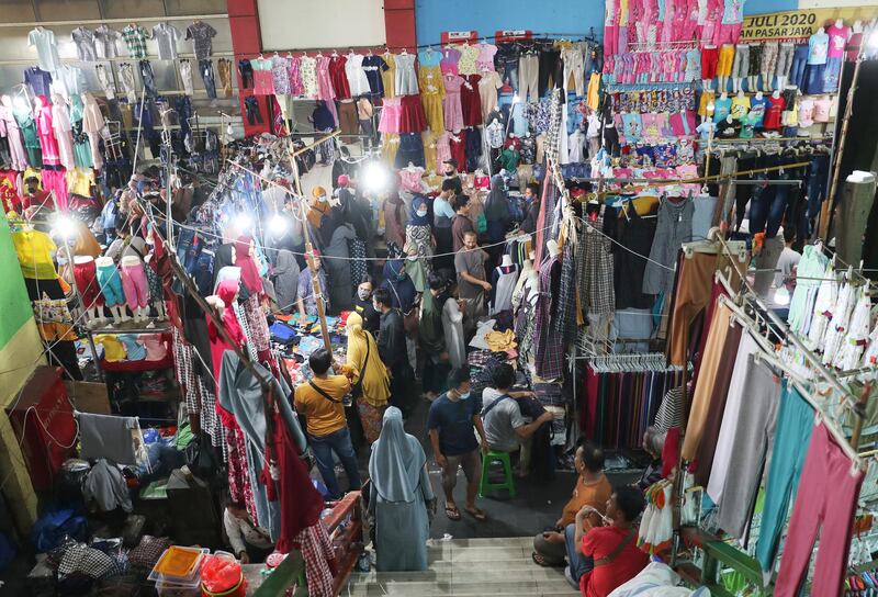 People wear masks to help curb the spread of coronavirus at a market in Jakarta, Indonesia. AP