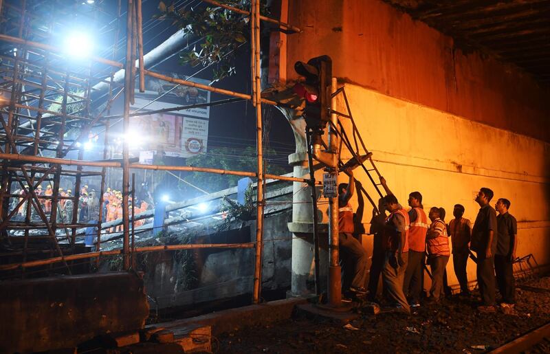Workers repair a damaged signal system. AFP