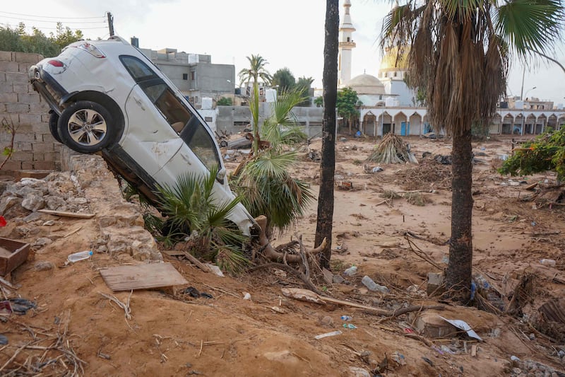 A car stuck in mud and rubble in the aftermath of flooding in Derna, eastern Libya. AFP