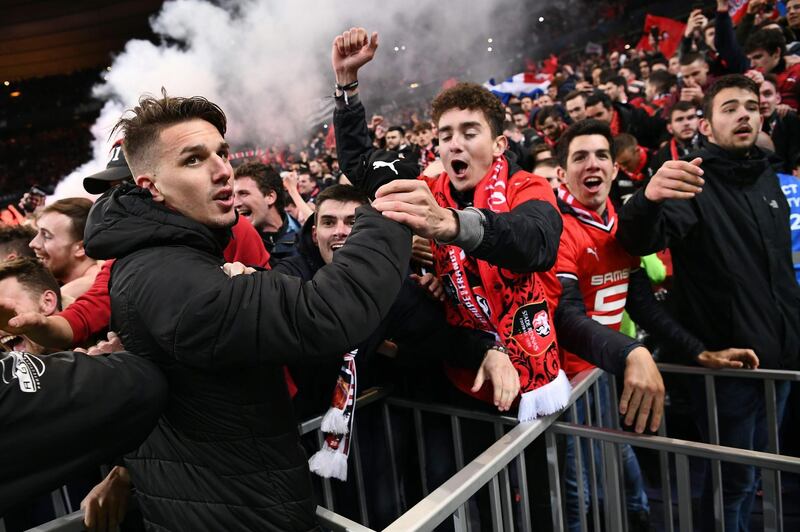 Rennes midfielder Adrien Hunou celebrates with supporters after winning the French Cup on Saturday night. Anne-Christine Poujoulat / AFP