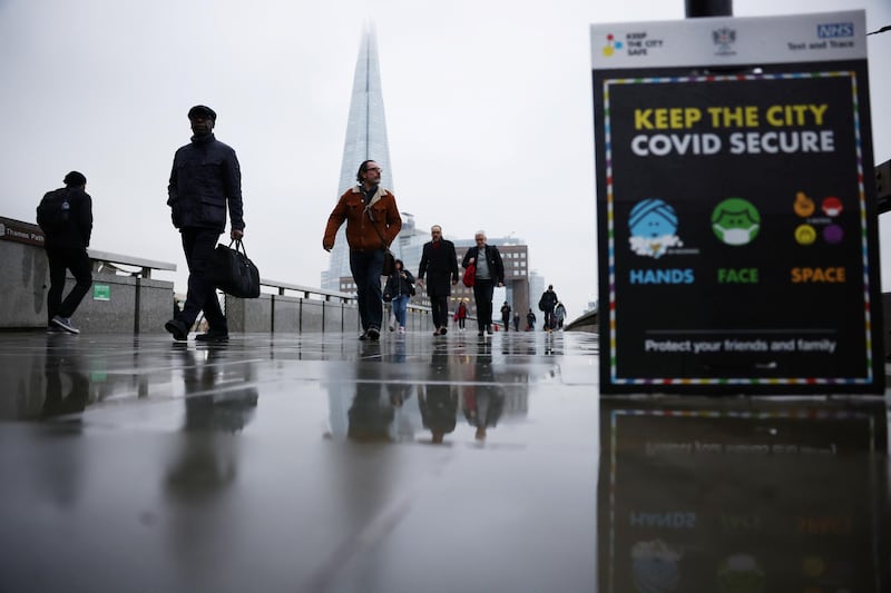 People walk over London Bridge during rush hour, amid the coronavirus disease (COVID-19) outbreak, in London, Britain, March 4, 2021.  REUTERS/Henry Nicholls