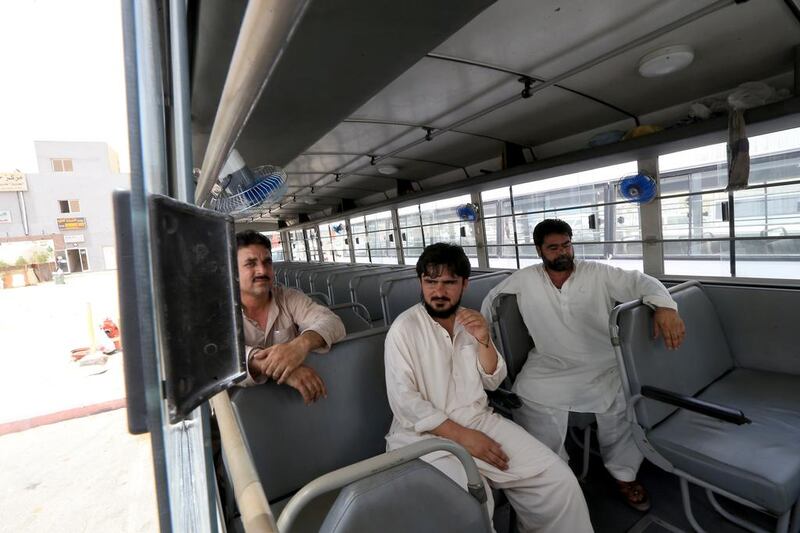 Workers’ bus drivers, from right, Jehangir Khan, Shakir Lachi and Mohammed Afridi talk about the dangers they face daily on the roads in their job. Ravindranath K / The National